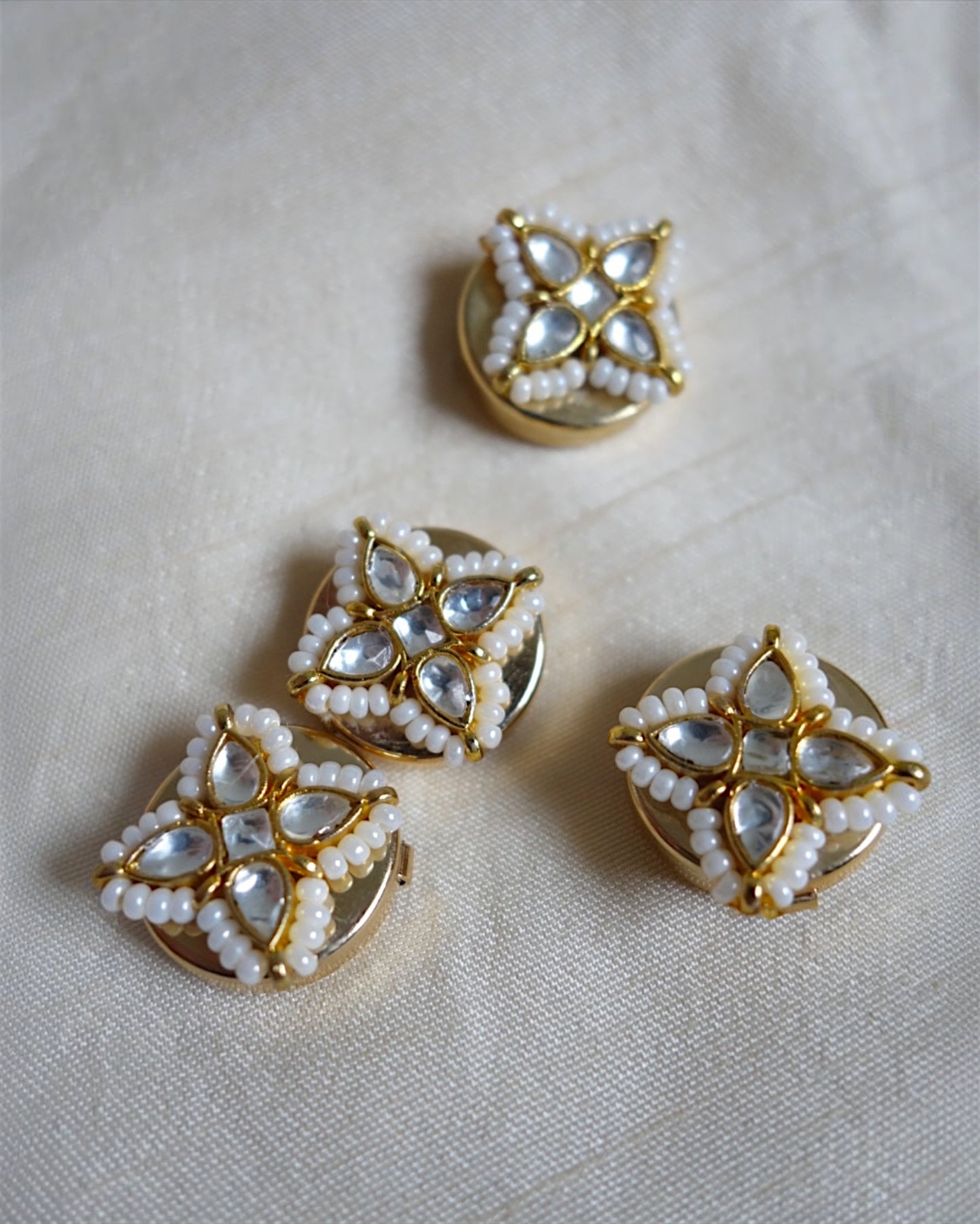 Four-petal floral button clips