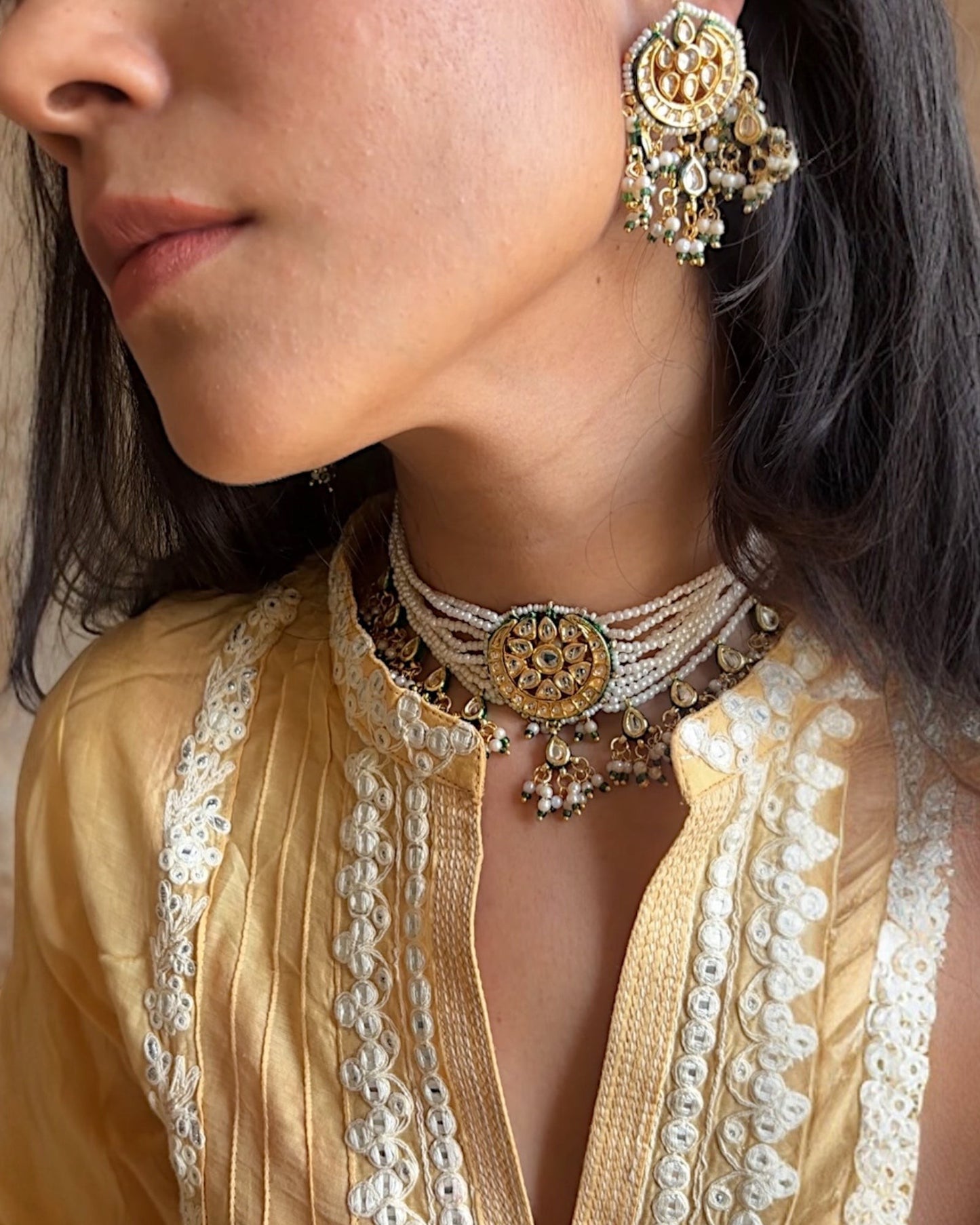Saanjh Jewels Padmini Pearl Choker Necklace Set with matching earrings, featuring gold-toned detailing and sparkling stones.