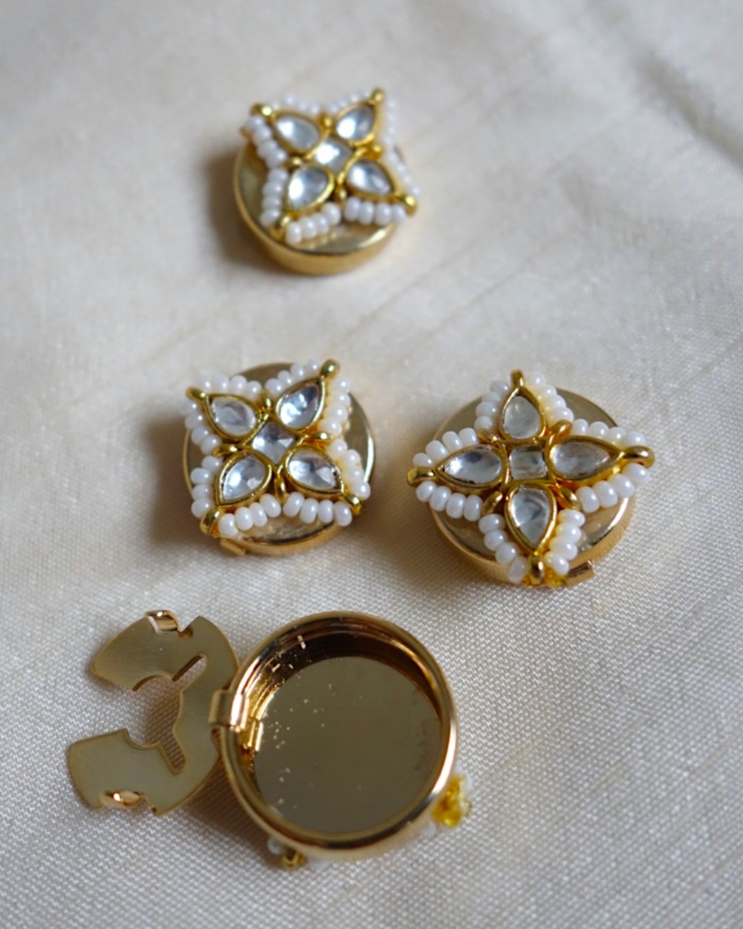 Four-petal floral button clips